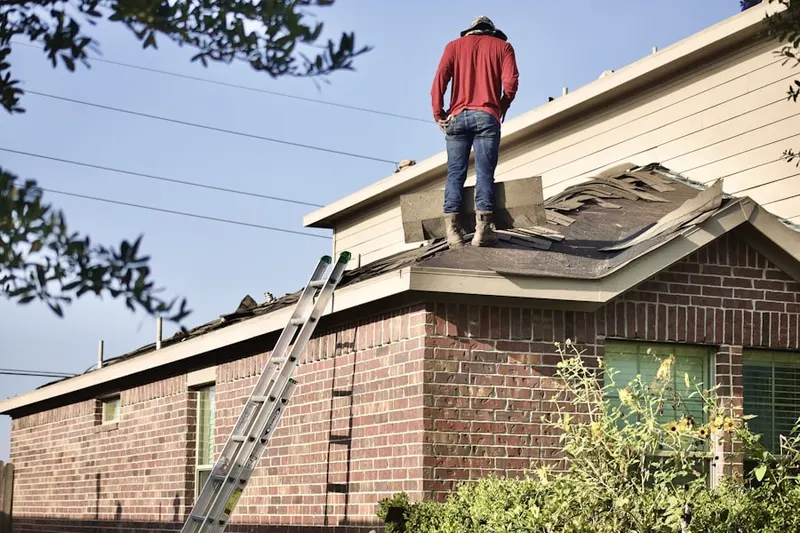 Professional roofer working on a residential roof in Leominster